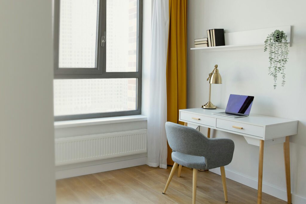 A desk and chair with a laptop on it, symbolizing a remote working environment.